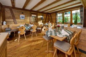 a dining room with wooden tables and chairs at Gasthaus Sonne in Münstertal