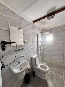 a bathroom with a white toilet and a sink at Petrinos Butik Otel in Datca