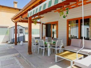 a patio with a table and chairs and a house at Luxury Rural Cuenca - Villas in Cuenca