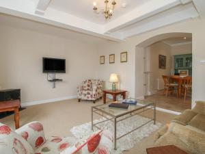 a living room with a couch and a table at The Old Nursery in Much Wenlock