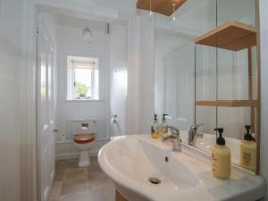 a white bathroom with a sink and a toilet at The Old Nursery in Much Wenlock +27 photos