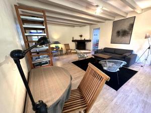 a living room with a couch and a table at Escapeteu in Azur +12 photos