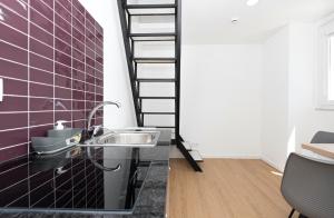 a bathroom with a sink and a spiral staircase at Solar da Fé in Atalaia +44 photos