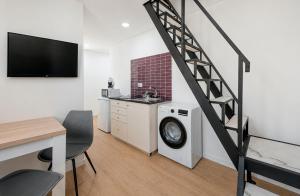 a living room with a staircase and a washing machine at Solar da Fé in Atalaia