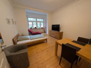 a living room with a bed and a table at Zimmervermietung an der Bebra in Sondershausen