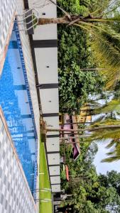 an overhead view of a building and a swimming pool at The Palm Retreat Luxe 1bhk Near Thivim Station in Advolpale