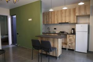 a kitchen with wooden cabinets and a white refrigerator at Newly Renovated 10 Min To Center in Gomi