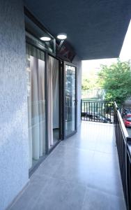 a balcony with sliding glass doors on a building at Newly Renovated 10 Min To Center in Gomi