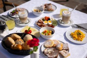 a table topped with plates of breakfast foods and drinks at B&B Garni Schorneck in Brunico
