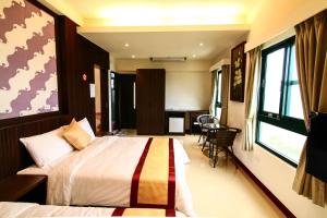 Rúm í herbergi á Penghu Luna Sea Homestay