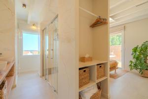 a bathroom with a shower and a glass shower stall at La Bali, Luxe et relaxation in La Ferté-Gaucher +31 photos