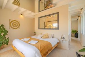 a bedroom with a large bed in a room at La Bali, Luxe et relaxation in La Ferté-Gaucher