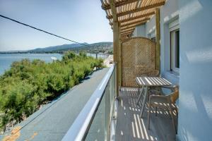 a balcony of a house with a table and chairs at Nyfida's four waves in Nifida