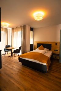 a hotel room with a bed and a table at Adler Apartments in Bach