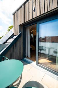 a house with a sliding glass door and a patio at Adler Apartments in Bach