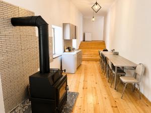a kitchen with a wood stove in a room at Eka's guest house in Mestia