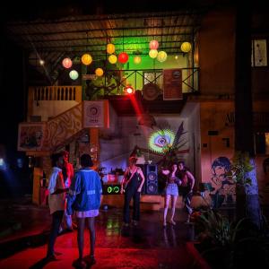 a group of people standing in front of a bar at Mandala House - Party hostel in Palolem