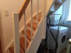 a staircase in a house with a washing machine at Ferienhaus Boddenblick in Stahlbrode