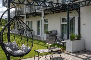 a swing in the yard of a house at Victoria Ustka Pokoje i Apartamenty Blisko Plaży in Ustka