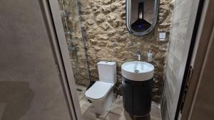a bathroom with a toilet and a sink at Stay In Zia in Asfendioú +43 photos