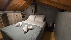 a bedroom with a large bed with towels on it at Stay In Zia in Asfendioú