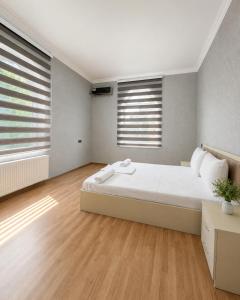 a bedroom with a large bed and two windows at Bilgah Coast Villa in Baku +34 photos