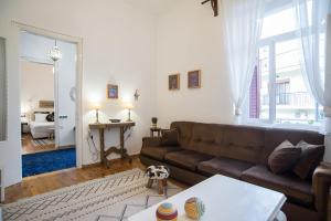 a living room with a brown couch and a table at Thalgiron, a breath away from Delphi in Ámfissa
