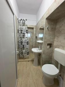 a bathroom with a toilet and a sink at Casa Raul Eforie Sud in Eforie Sud