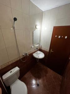 a bathroom with a toilet and a sink at Angel in Primorsko