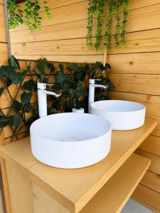 a bathroom with two sinks on a wooden counter at Bulamac Luxury Glamping in Vama Veche