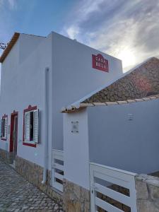 a white building with a sign on the side of it at Casa Bela in Sagres