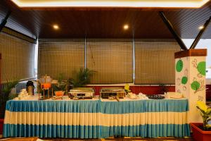 a kitchen with a table with a blue and yellow at Treebo Ksheera Residency Near Railway Station in Hassan