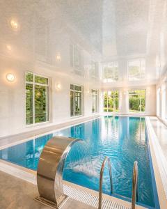 a large swimming pool with a water slide in a house at Bilgah Coast Villa in Baku