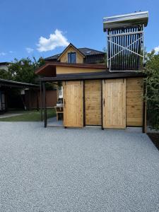 a garage with wooden doors and a balcony at Bulamac Luxury Glamping in Vama Veche