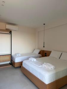 a bedroom with two beds with towels on them at Soléa Himara Guesthouse in Himare