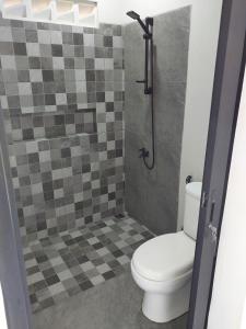 a bathroom with a toilet and a shower at Slab Krui Bungalows in Krui