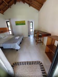a room with two beds and a desk in it at Slab Krui Bungalows in Krui