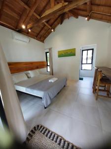 a large room with a bed and a piano at Slab Krui Bungalows in Krui