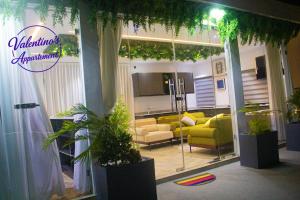 a lobby with couches and plants in a building at Valentinos Appartement Prestige in Agbodrafo