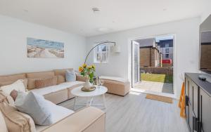 a living room with a couch and a table at Seagrass in Sandown