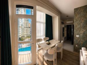 a room with a table and chairs and a large window at Otel Grand Lark İstanbul in Istanbul
