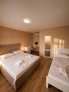 a large bedroom with two beds and a table at LOTUS Hotel Solotvino in Solotvyno