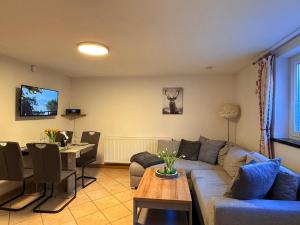 a living room with a couch and a table at Naturhof Kluge in Saupsdorf