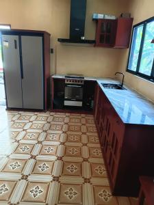 a kitchen with a stove and a refrigerator at Dorz Inn in Moalboal