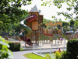 a playground with a slide in a park at Camping Pays Basque in Bidart