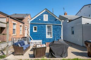 a blue house with a couch and chairs on a patio at Historical John H Dickman House in Covington