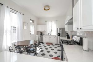 a kitchen with a table and some chairs in it at Historical John H Dickman House in Covington
