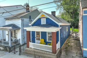 a blue house with a chair on the porch at Historical John H Dickman House in Covington +31 photos