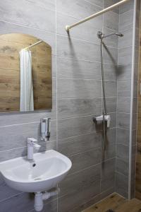 a bathroom with a sink and a shower at LOTUS Hotel Solotvino in Solotvyno