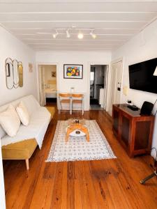 a living room with a couch and a table at Central Lisbon Apartment Santos Walk to Cais do Sodré in Lisbon